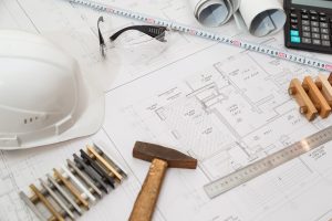 Architect or engineer workplace with drawings and tools