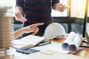 professional architect designer structural engineer team colleagues working office looking computer